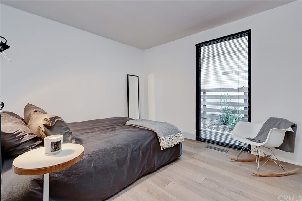 4413 Grimes Place Encino, CA 91316 - Photo 19 of 26 a bedroom with a bed and a chair