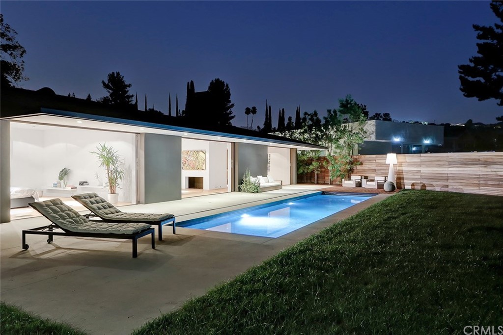 4413 Grimes Place Encino, CA 91316 - Photo 24 of 26 a view of a swimming pool with lawn chairs and a yard