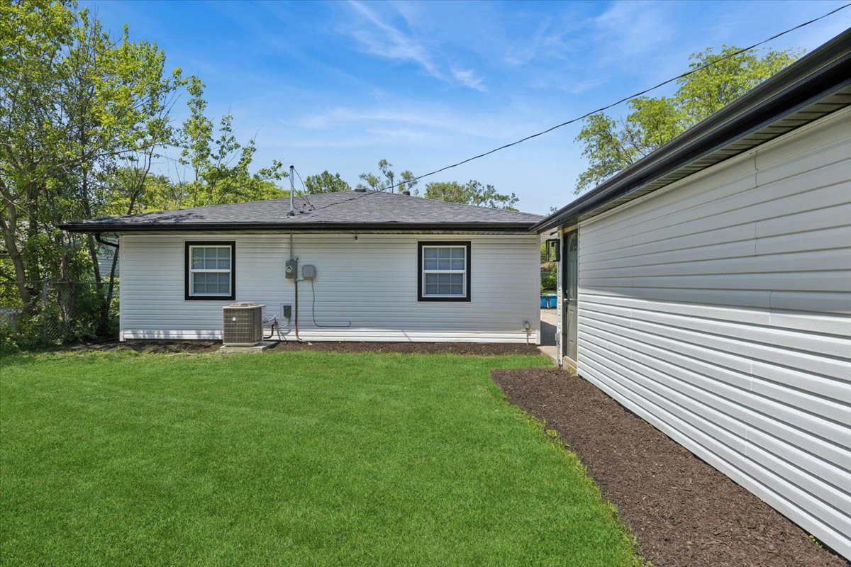 570 Andover Street Chicago Heights, IL 60411 - Photo 22 of 22 a backyard of a house with table and chairs
