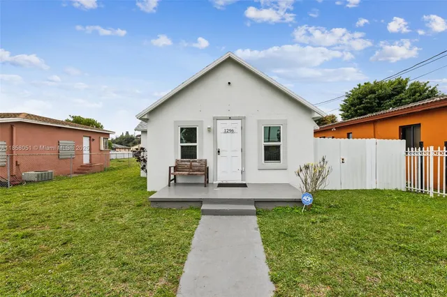 a front view of a house with a yard and porch
