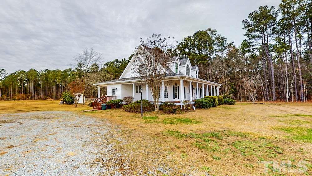 1560 Beasley Road Benson, NC 27504 - Photo 3 of 27 a front view of a house with swimming pool and porch with furniture