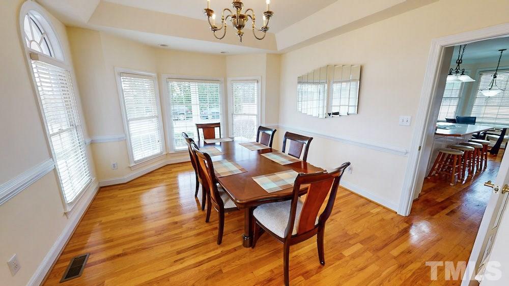 1560 Beasley Road Benson, NC 27504 - Photo 6 of 27 a view of a dining room with furniture window and wooden floor