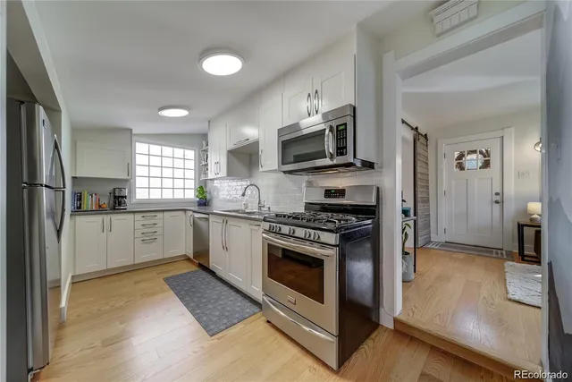 a kitchen with a stove a sink and a microwave