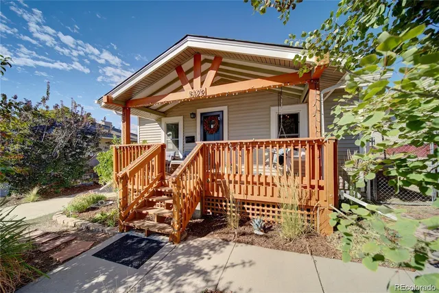 a view of a house with a wooden fence