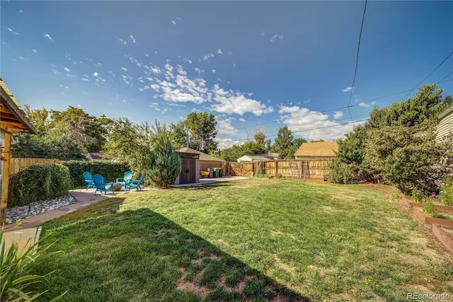 a view of a house with a big yard and potted plants