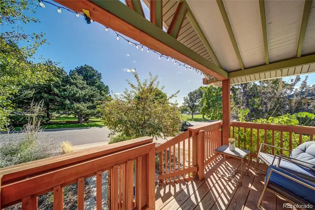 a view of balcony with wooden floor and outdoor seating
