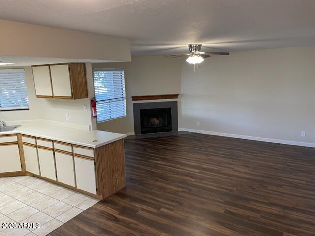 a view of a livingroom with wooden floor and a fireplace