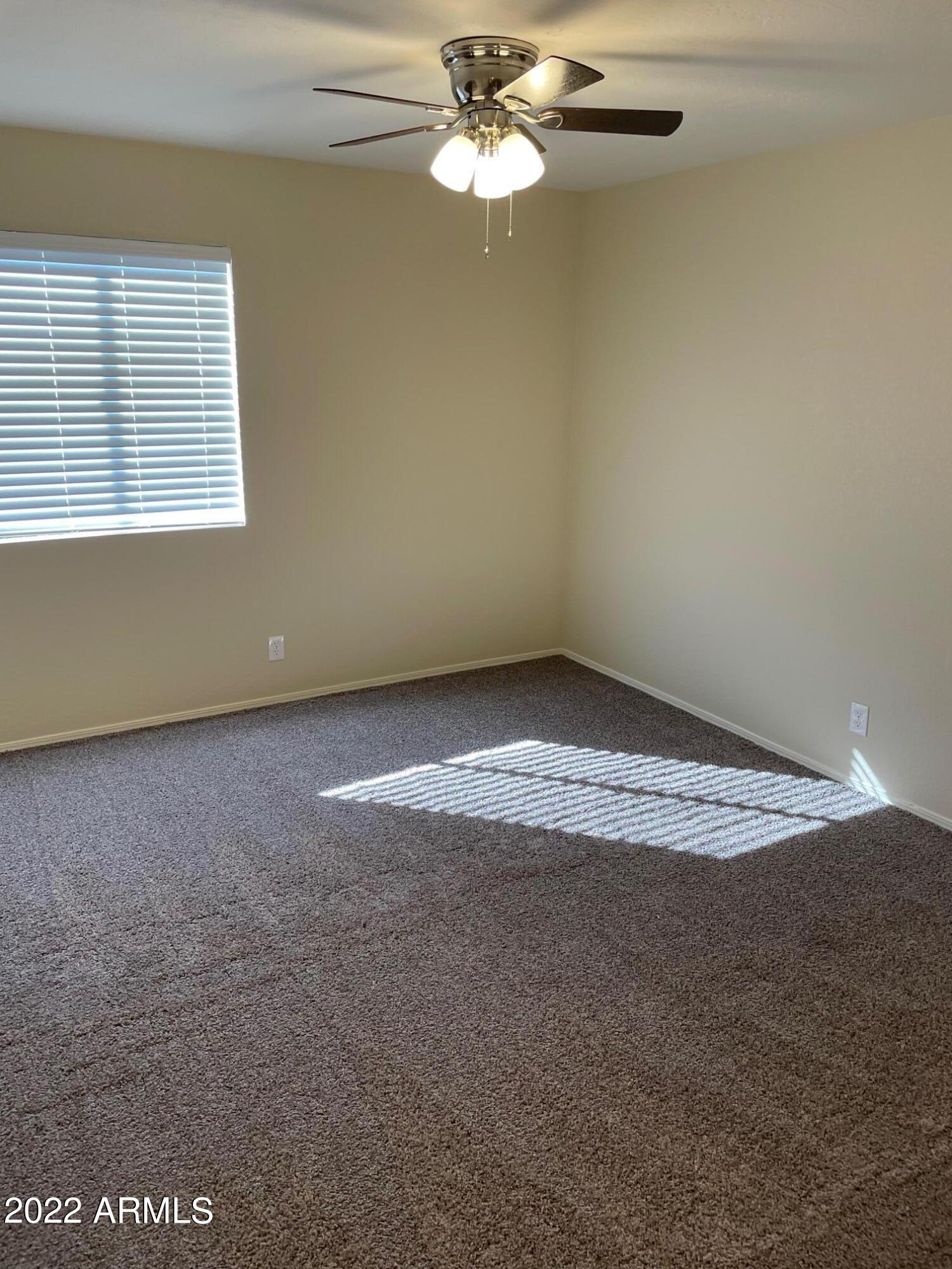 1444 North Recker Road, Unit 167 Mesa, AZ 85205 - Photo 11 of 13 a view of a room with window and ceiling fan