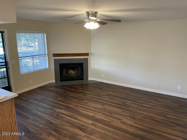 1444 North Recker Road, Unit 167 Mesa, AZ 85205 - Photo 3 of 13 wooden floor fireplace and natural light in empty room