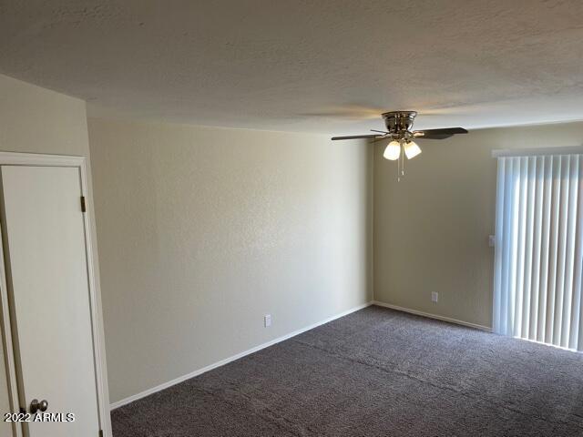 1444 North Recker Road, Unit 167 Mesa, AZ 85205 - Photo 8 of 13 an empty room with a fan & a window