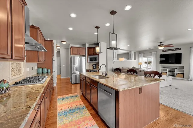 a bathroom with a granite countertop sink a mirror and a shower