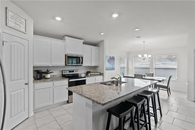 a kitchen with granite countertop a sink and a stove