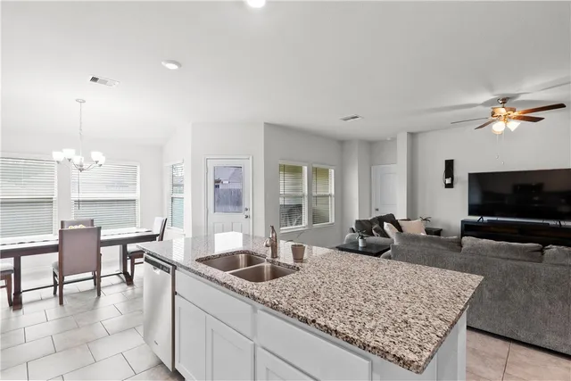 a kitchen with stainless steel appliances granite countertop a sink a stove a microwave and cabinets