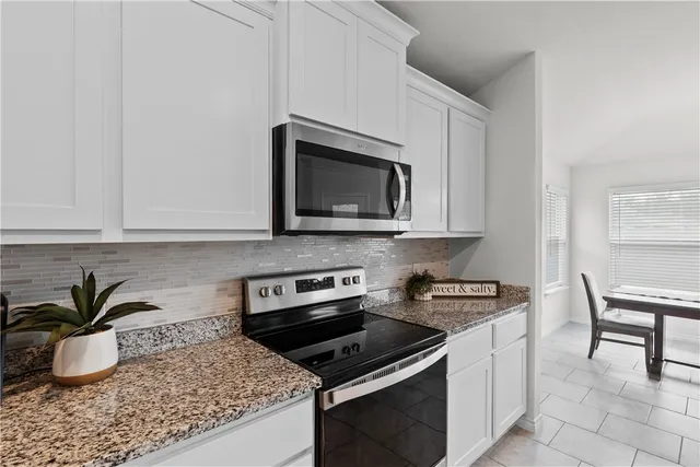 a kitchen with a refrigerator and a sink