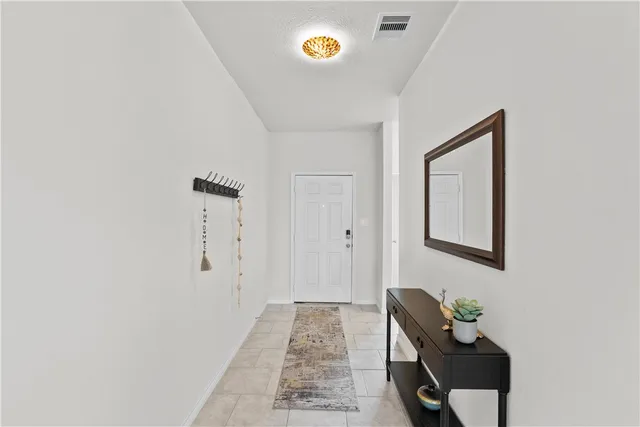 a living room with furniture a dining table and a refrigerator