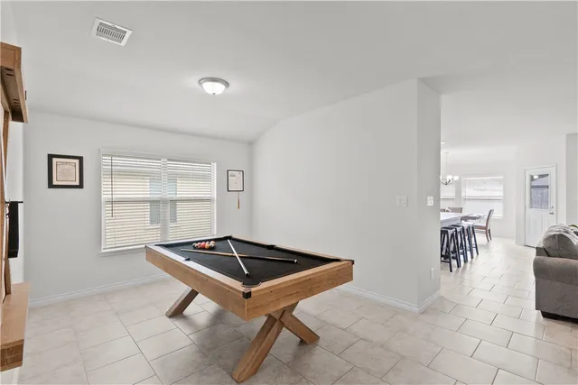 a backyard of a house with table and chairs