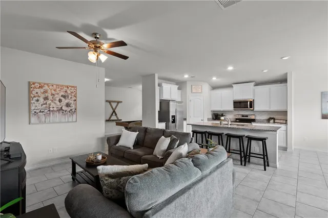 a kitchen with stainless steel appliances granite countertop a stove a sink a microwave a refrigerator and cabinets