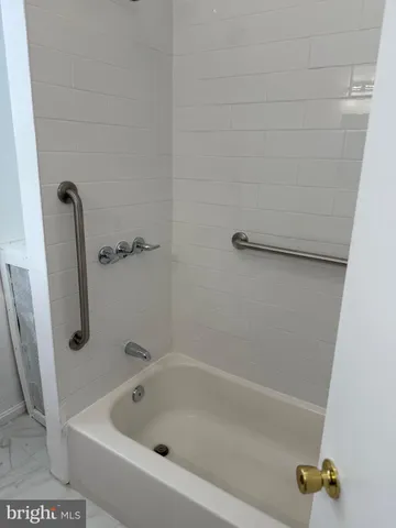 a white bath tub sitting in a bathroom