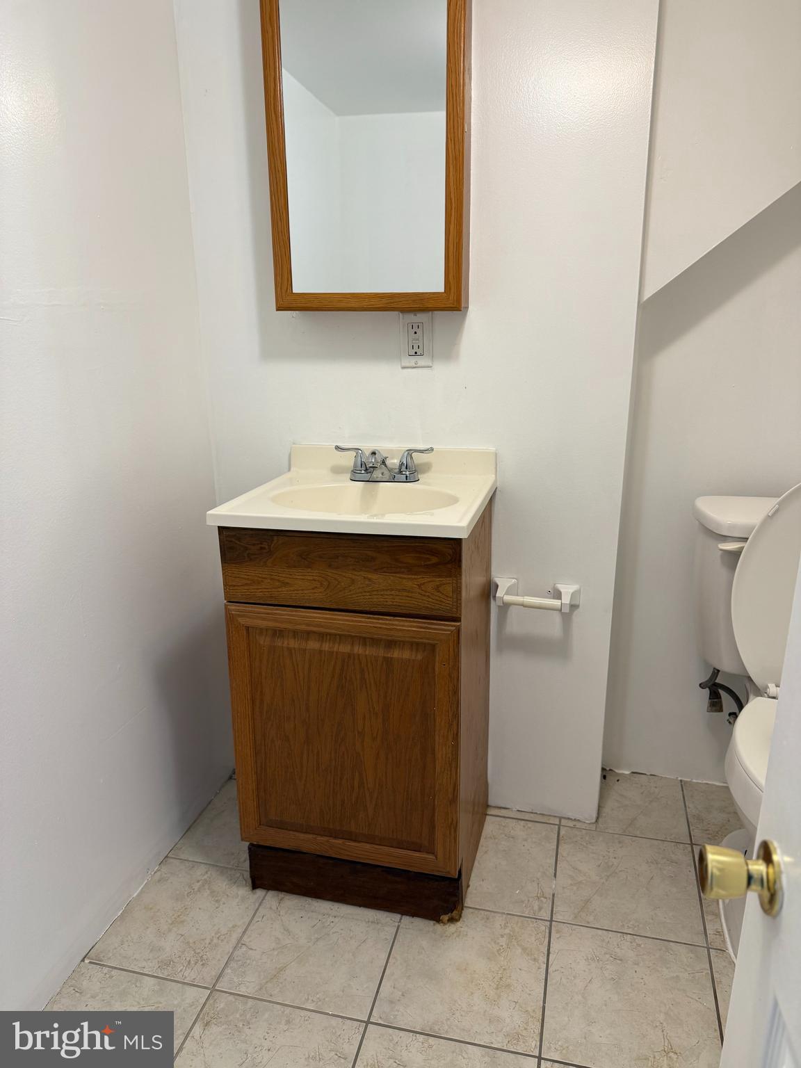 2807 Presstman Street Baltimore, MD 21216 - Photo 4 of 24 a bathroom with a sink and a toilet