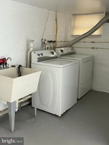 a kitchen with sink and white cabinets