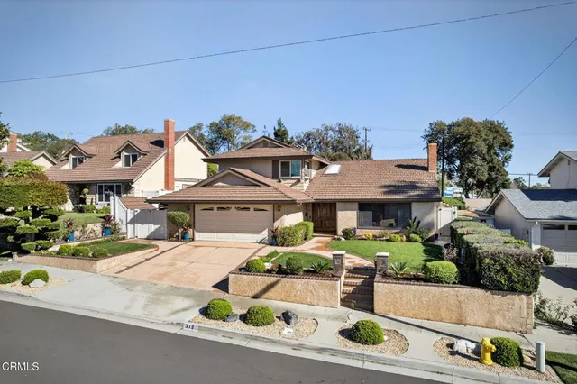 an aerial view of a house with swimming pool and garden