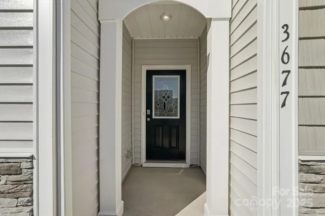 a view of a hallway with wooden floor and entryway