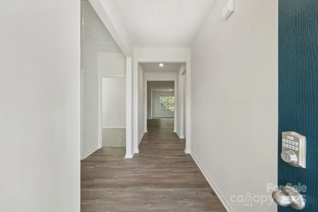 a view of a hallway with wooden floor