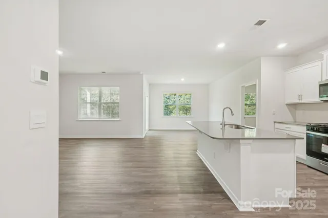a view of kitchen with sink and wooden floor