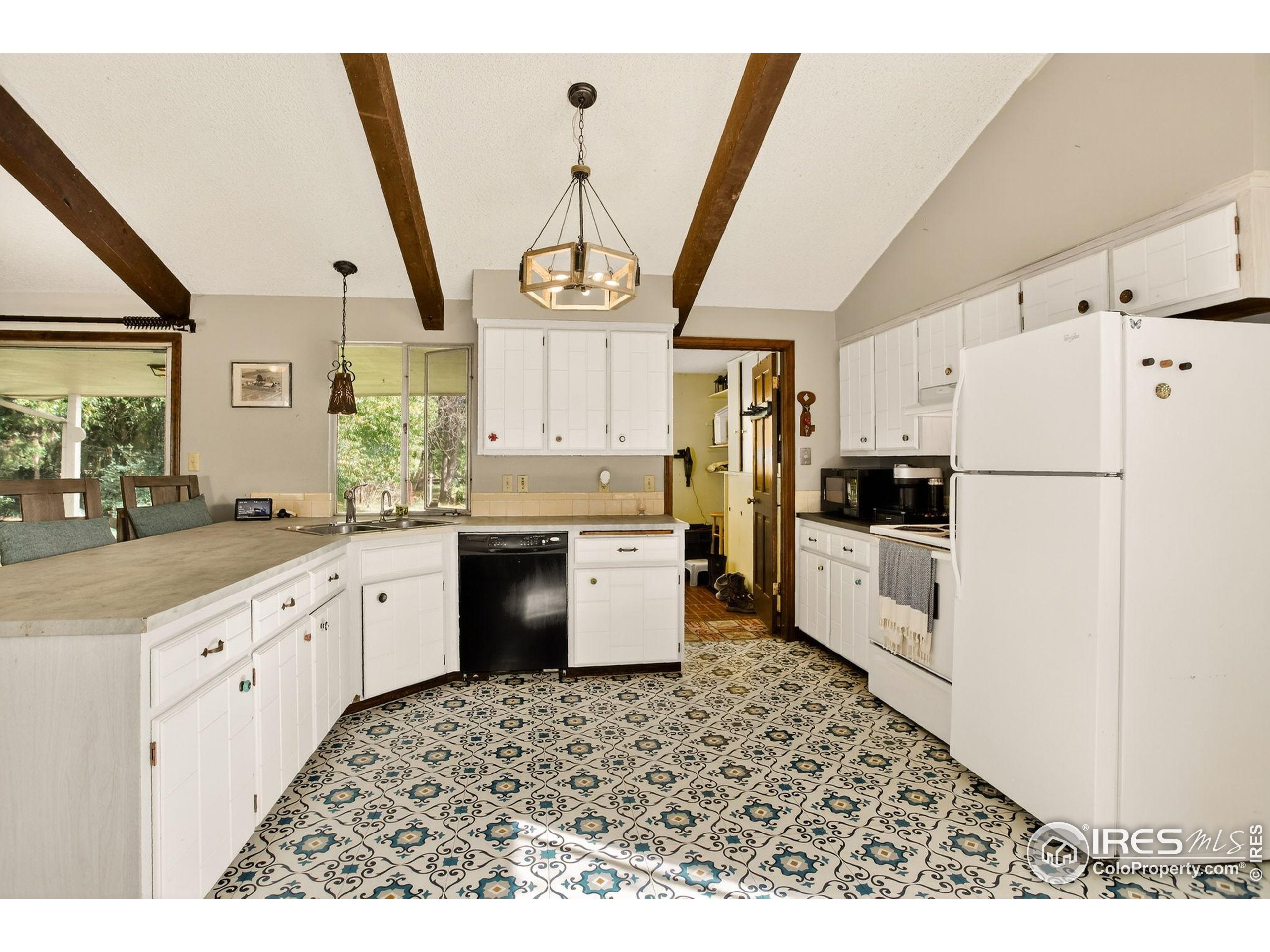 3625 Nimbus Road Longmont, CO 80503 - Photo 15 of 48 a kitchen with granite countertop a refrigerator a sink dishwasher a stove top oven a refrigerator with island and cabinets