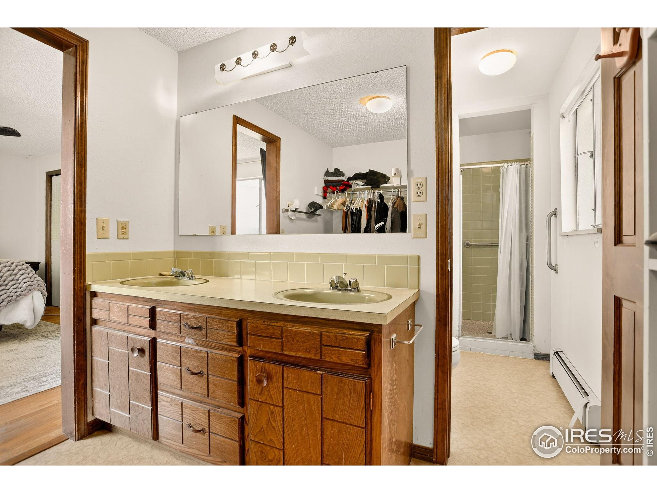 3625 Nimbus Road Longmont, CO 80503 - Photo 18 of 48 a bathroom with a sink a mirror and a vanity