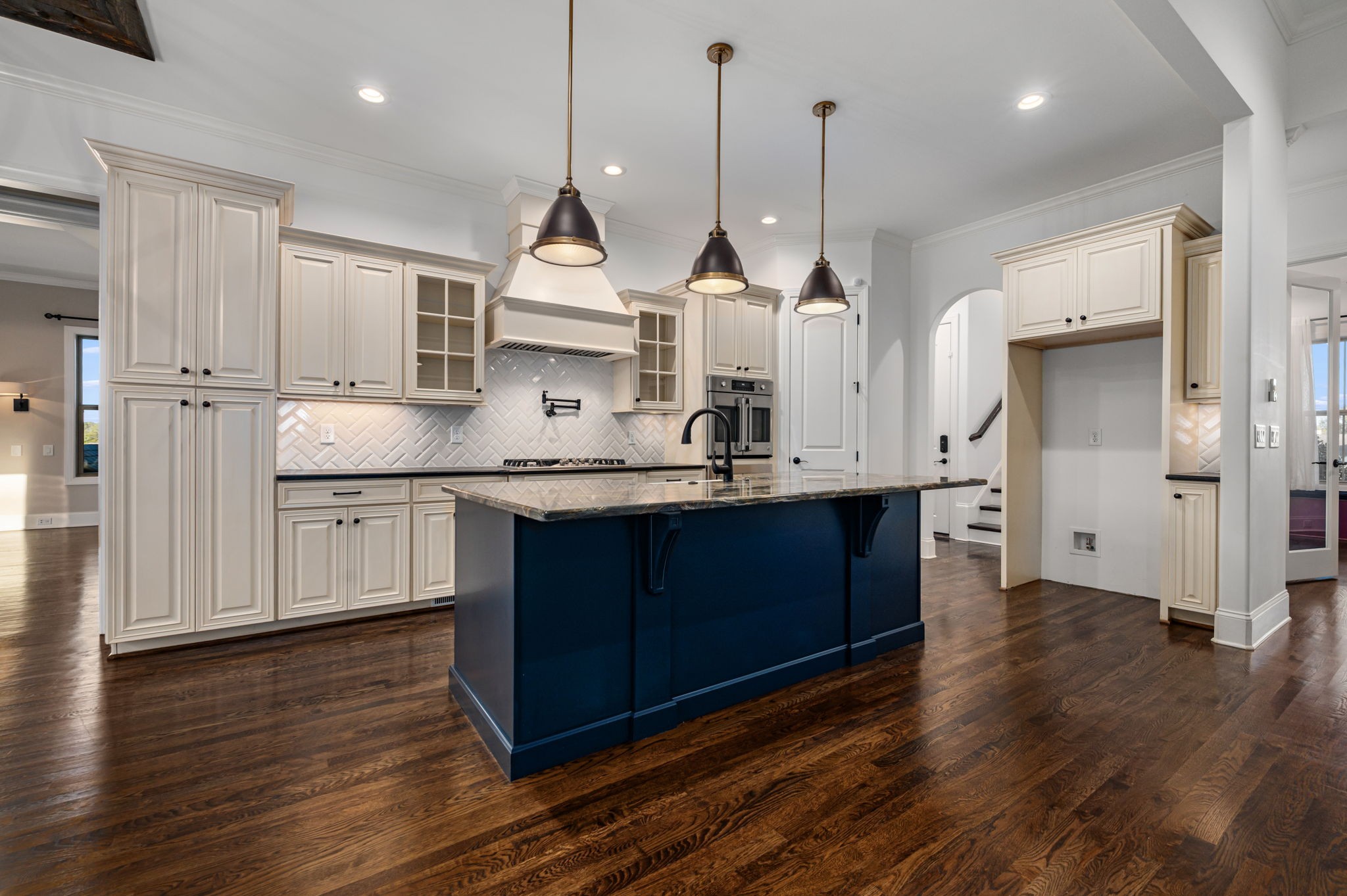 4016 Pinwheel Court Arrington, TN 37014 - Photo 4 of 47 a kitchen with stainless steel appliances granite countertop a sink a stove a refrigerator and white cabinets with wooden floor