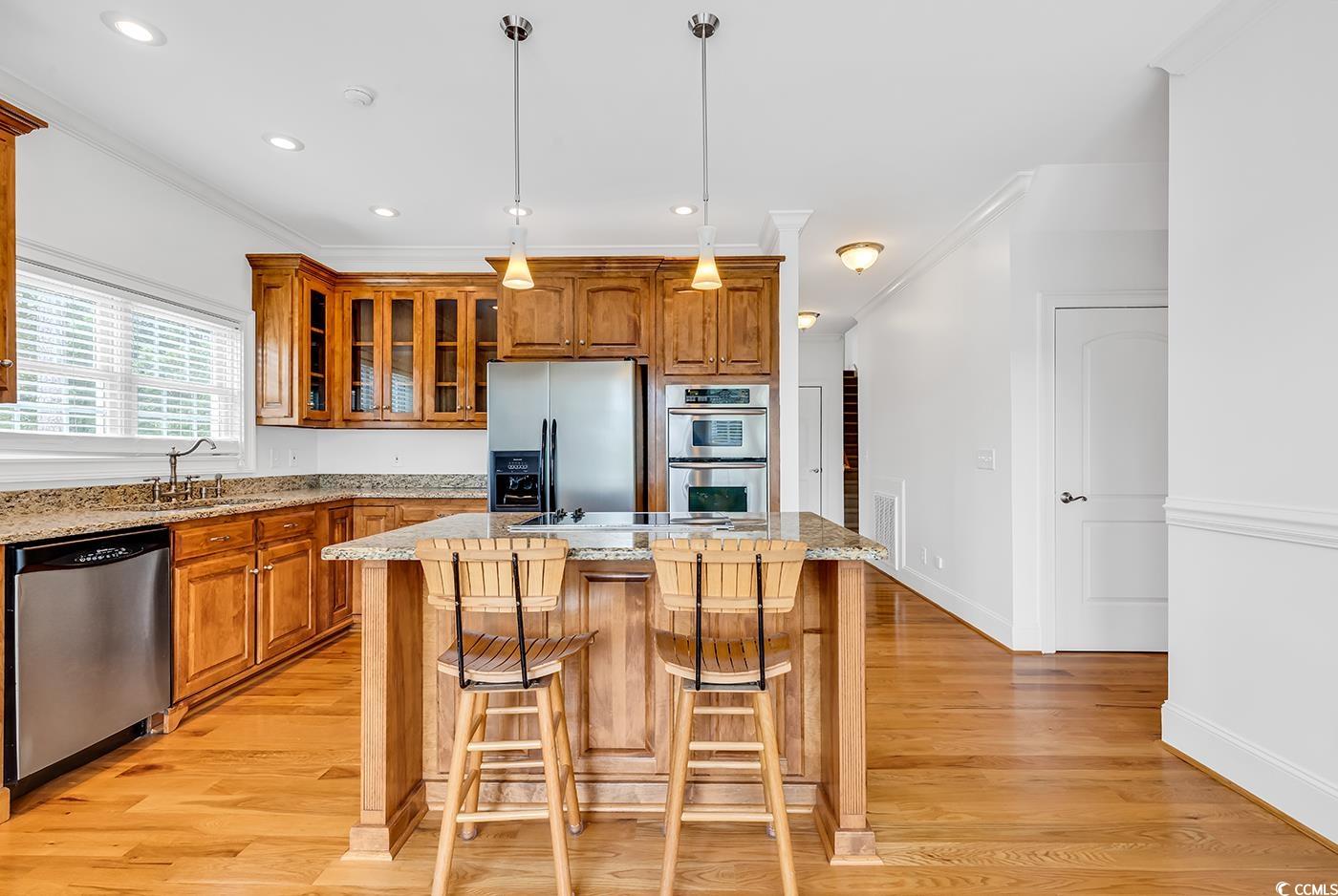 70 Highwood Circle Murrells Inlet, SC 29576 - Photo 21 of 40 Kitchen with a center island, a kitchen bar, stain