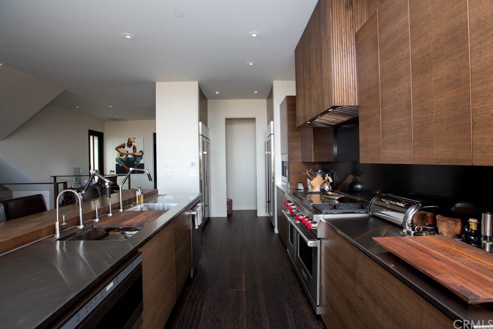 1839 Strand Way Oceano, CA 93445 - Photo 20 of 47 a kitchen with kitchen island granite countertop a sink appliances cabinets and a counter top space