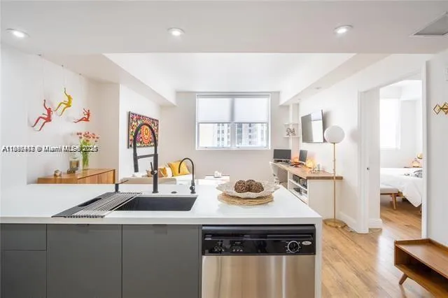 a kitchen with a sink a stove and cabinets