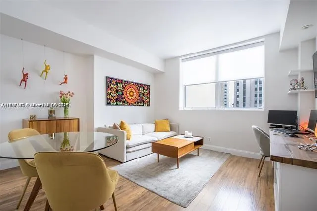 a living room with furniture a piano and a window