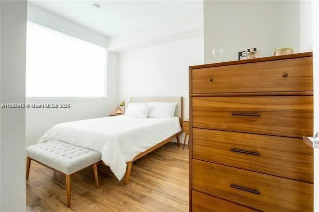 a bedroom with a bed and a dresser