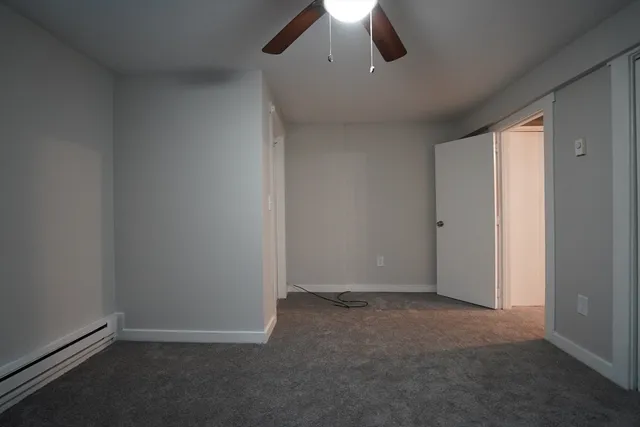 an empty room with a empty space and a ceiling fan