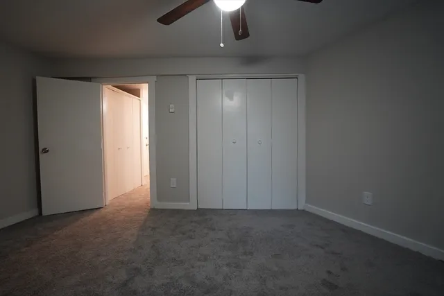 an empty room with a empty space and a ceiling fan