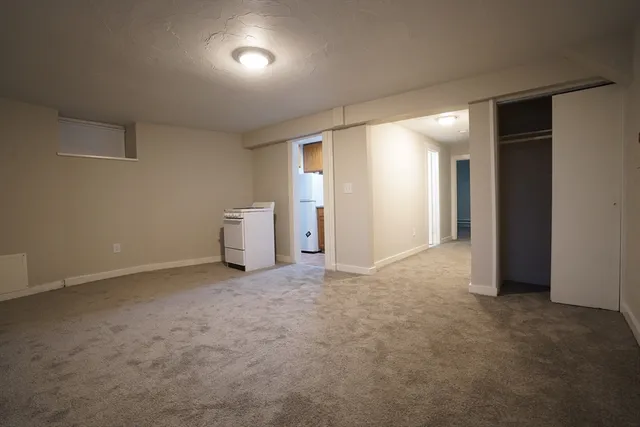 an empty room with closet and mirror