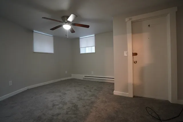 an empty room with closet and a ceiling fan
