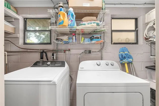 a living room with a large window and furniture