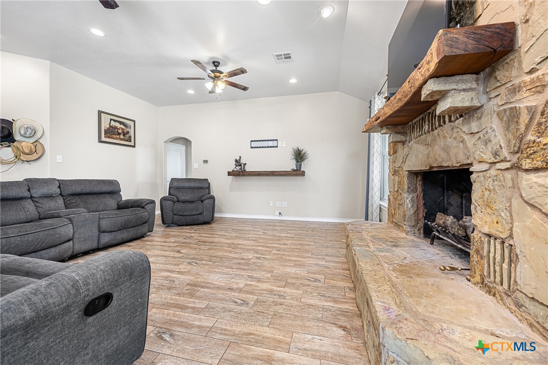 16101 Dove Road Moody, TX 76557 - Photo 16 of 42 a living room with furniture a fireplace and a ceiling fan