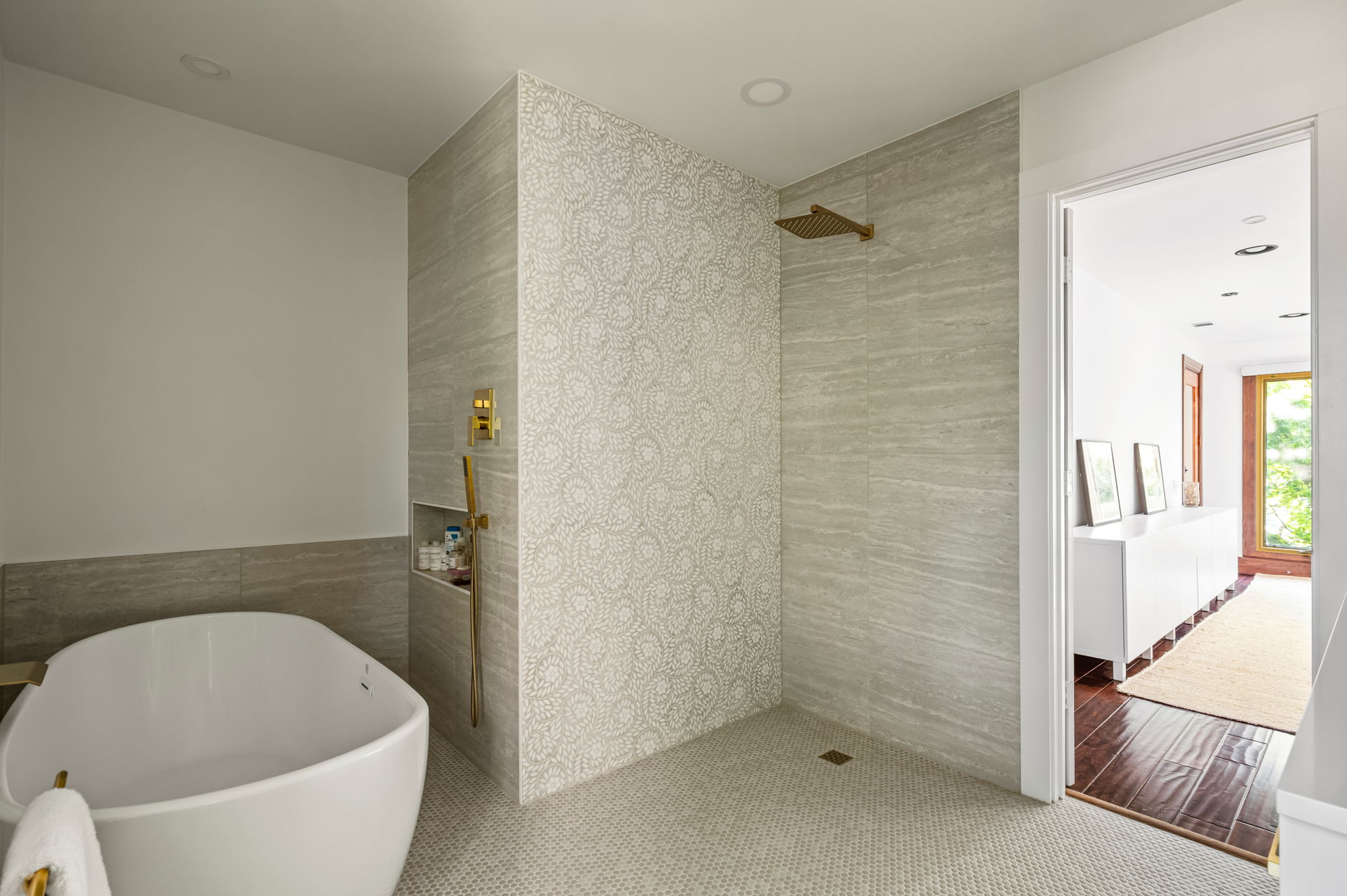 1111 West 12th Street, Unit 107 Austin, TX 78703 - Photo 29 of 38 Freestanding soaking tub and walk-in shower featuring a rain shower head and a built-in niche