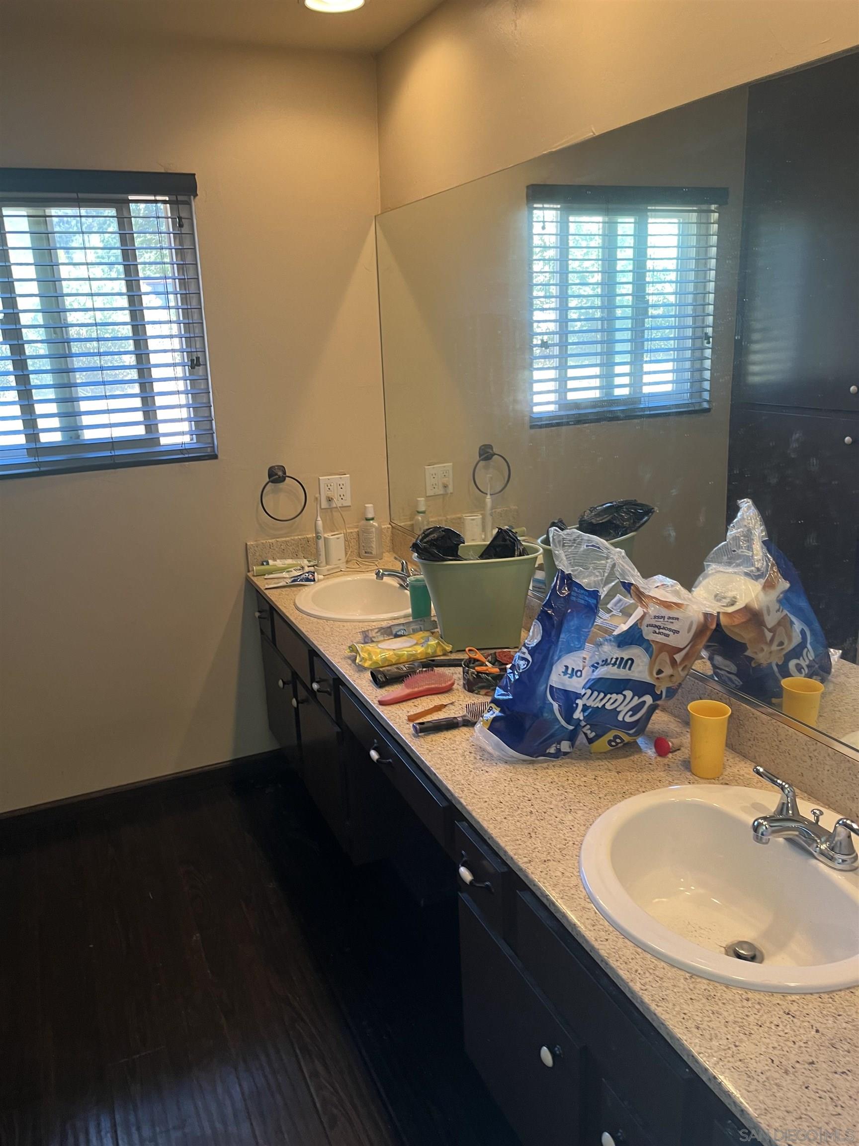 1407 Taylor Vista Vista, CA 92084 - Photo 24 of 28 a bathroom with a double vanity sink and a mirror