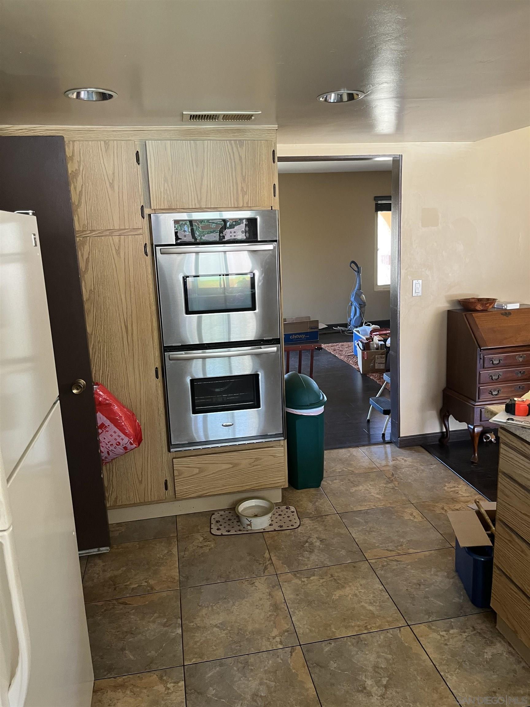 1407 Taylor Vista Vista, CA 92084 - Photo 5 of 28 a living room with furniture a flat screen tv and a stove