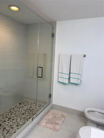 a bathroom with a toilet and a shower