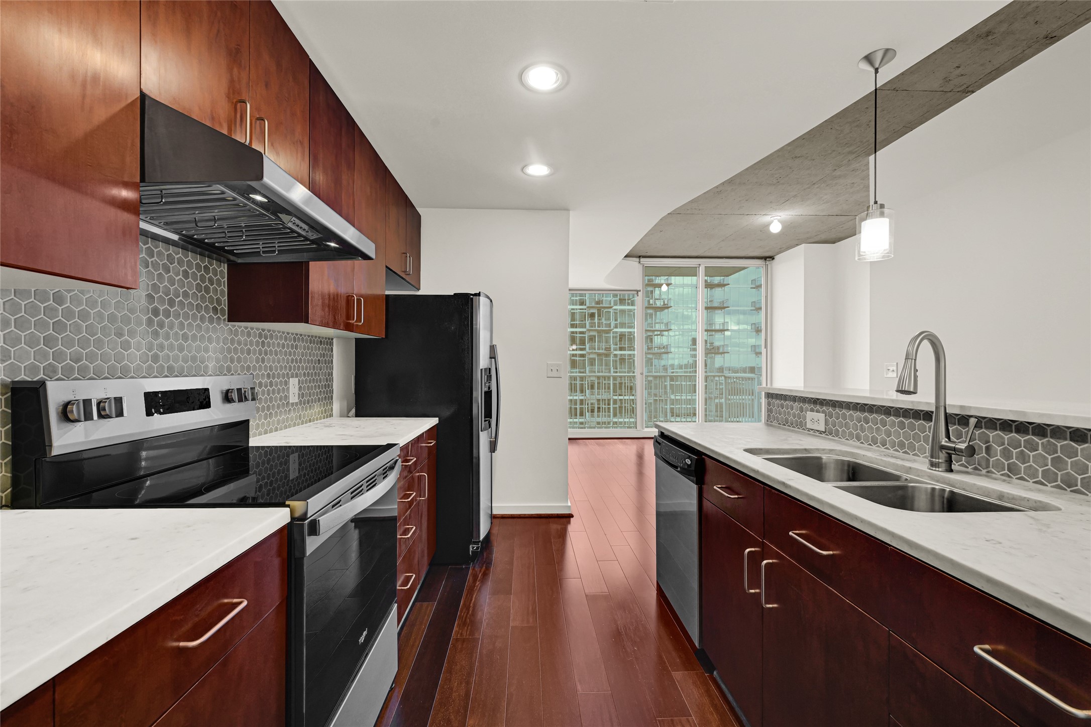 Kitchen with new vent hood, range, faucet and disposal