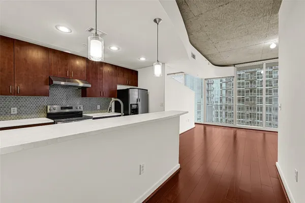 a view of a kitchen with a sink and a large window