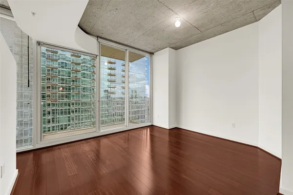 a view of wooden floor and windows in a room