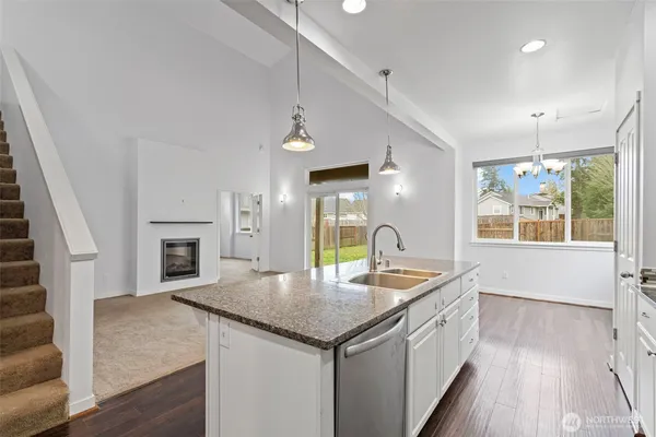 a kitchen with granite countertop a sink and stove